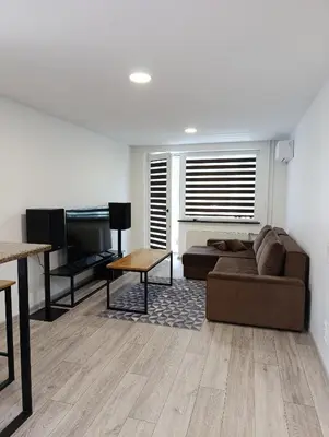 a living room with a couch and a piano at Alytus Miško studio in Alytus