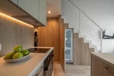 a kitchen with a bowl of fruit on a counter at Loft 12 in Vilnius