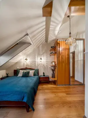 a bedroom with a bed with a blue comforter at Old Town Traku street apartment in Vilnius