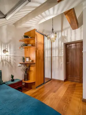 a bedroom with a bed and a wooden cabinet at Old Town Traku street apartment in Vilnius