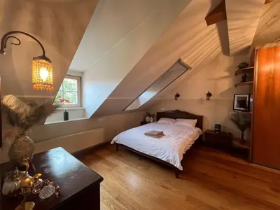 a bedroom with a bed in an attic at Old Town Traku street apartment in Vilnius