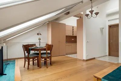 a dining room and kitchen with a table and chairs at Old Town Traku street apartment in Vilnius
