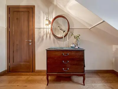 a dresser with a mirror on top of it next to a door at Old Town Traku street apartment in Vilnius