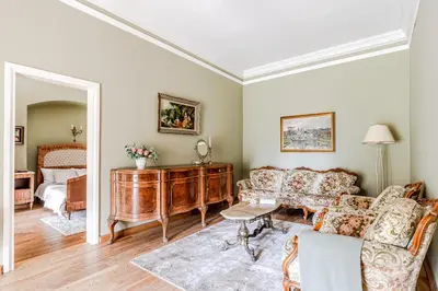 a living room with a couch and a table at Taujėnų dvaro rūmai in Towiany