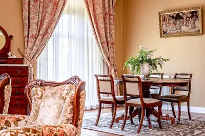 a dining room with a table and chairs at Taujėnų dvaro rūmai in Towiany