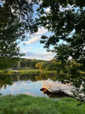 a dock on a lake with a golf course at Namelis prie Čiobiškio kelto