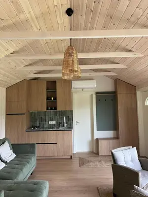 a living room with a couch and a table at Namelis prie Čiobiškio kelto