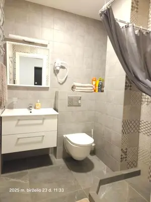 a bathroom with a toilet and a sink and a mirror at Happy Inn Sweet Old Town Studio, Self check in, Parking in Vilnius