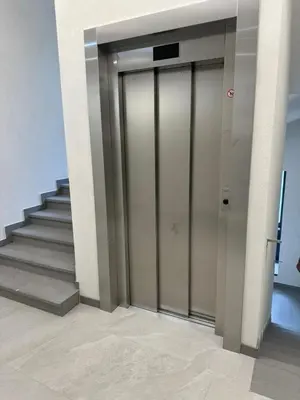 an elevator in a building with a staircase at Rambynas R36 in Panevėžys
