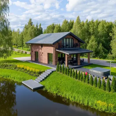 a house with a river in front of it at Galuonų vilos in Inturkė