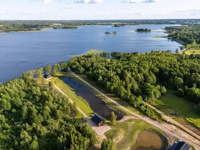 an aerial view of a lake with a farm at Galuonų vilos in Inturkė