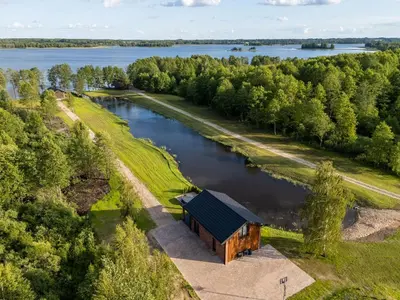 an aerial view of a wooden building next to a river at Galuonų vilos in Inturkė