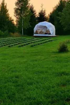 a large white tent in a field of grass at Kvapu sodyba