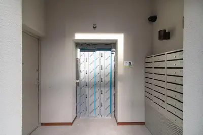 a hallway with a large door in a room at Brand-new & Stylish Loft - Hip District Uptown by Reside Baltic in Vilnius