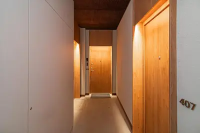 a corridor of a hallway with wooden doors at Brand-new & Stylish Loft - Hip District Uptown by Reside Baltic in Vilnius