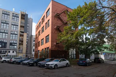 a row of cars parked in front of a building at Brand-new & Stylish Loft - Hip District Uptown by Reside Baltic in Vilnius