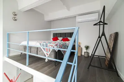a bedroom with a bunk bed in a loft at Brand-new & Stylish Loft - Hip District Uptown by Reside Baltic in Vilnius