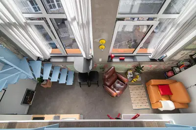 an overhead view of a living room with orange furniture at Brand-new & Stylish Loft - Hip District Uptown by Reside Baltic in Vilnius
