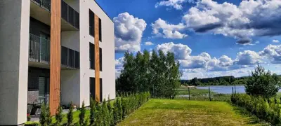 a building with a grass yard next to a building at Light House in Vilnius