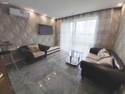 a living room with two couches and a television at Light House in Vilnius