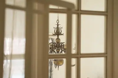 a chandelier is seen through a window at Provence Home in Vilnius