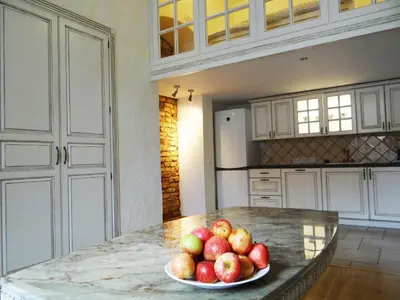 a bowl of apples on a counter in a kitchen at Provence Home in Vilnius