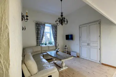 a living room with a couch and a table at Provence Home in Vilnius