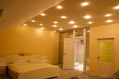 a bedroom with a bed and a mirror at Apartamentai Lampėdžiuose in Kaunas