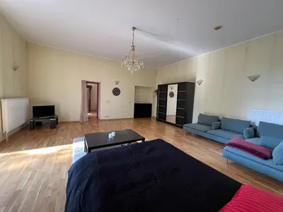 a living room with two blue couches and a television at Apartamentai Lampėdžiuose in Kaunas