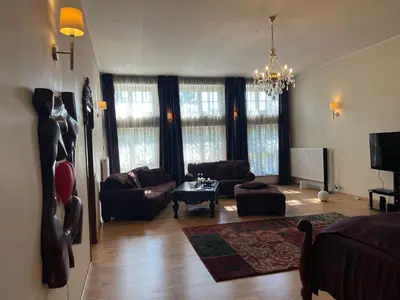 a living room with a couch and a table at Apartamentai Lampėdžiuose in Kaunas