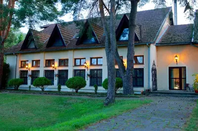 a white house with a brown roof at Apartamentai Lampėdžiuose in Kaunas