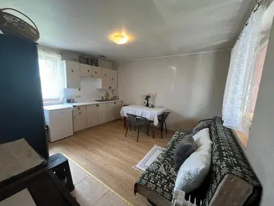 a living room with a couch and a table at Sodyba prie Ąžuolo