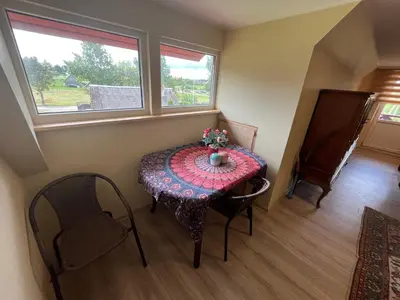 a small room with a table and a window at Sodyba prie Ąžuolo