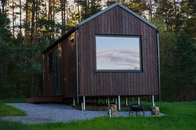 a building with a large window on the side of it at MyRetreat - cabin for two