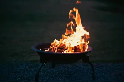 a fire in a grill with flames in it at MyRetreat - cabin for two