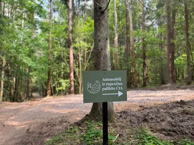a sign in front of a tree in a forest at MyRetreat - cabin for two