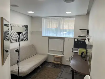 a small room with a couch and a desk at Cozy Traku Studio in Kaunas