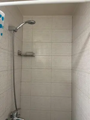 a shower with a shower head in a bathroom at Cozy Traku Studio in Kaunas