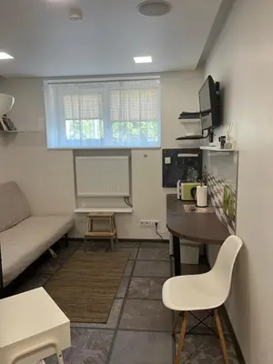a living room with a table and a couch at Cozy Traku Studio in Kaunas