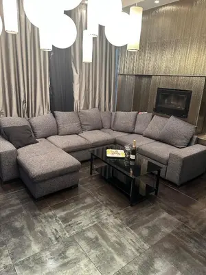 a living room with a couch and a table at B&M Jacuzzi Rezidencija SELF CHECK - IN in Vilnius