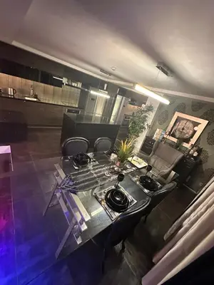 a dining room with a table and chairs in a room at B&M Jacuzzi Rezidencija SELF CHECK - IN in Vilnius