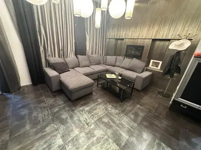a living room with a couch and a tv at B&M Jacuzzi Rezidencija SELF CHECK - IN in Vilnius