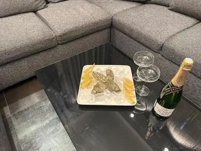 a plate of food and a bottle of wine on a table at B&M Jacuzzi Rezidencija SELF CHECK - IN in Vilnius
