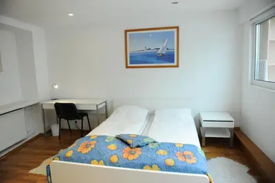 a bedroom with a bed and a desk and a window at Best Location 3 Bedroom Apartment in Vilnius