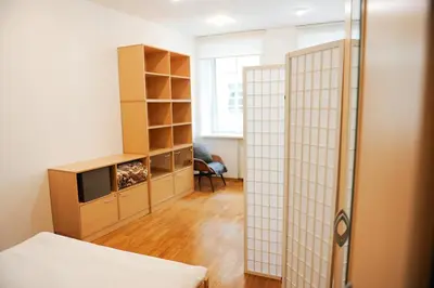 a room with a bed and a closet and a tv at Best Location 3 Bedroom Apartment in Vilnius