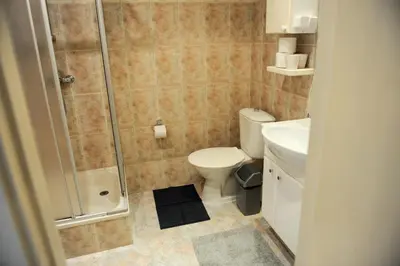 a bathroom with a shower and a toilet and a sink at Best Location 3 Bedroom Apartment in Vilnius