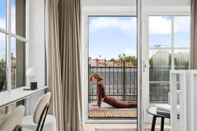 a young woman doing yoga on the balcony of a hotel room at Elegant Apartments in Vilnius Center, 11 in Vilnius