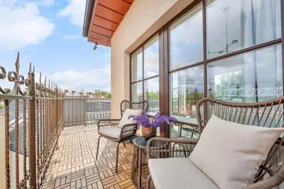 a balcony with chairs and tables and windows at Elegant Apartments in Vilnius Center, 11 in Vilnius