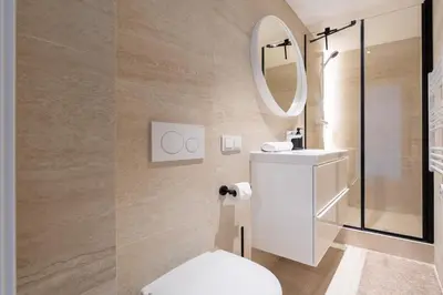 a bathroom with a toilet and a mirror at Elegant Apartments in Vilnius Center, 11 in Vilnius