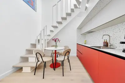 a kitchen with a table and chairs and stairs at Elegant Apartments in Vilnius Center, 11 in Vilnius